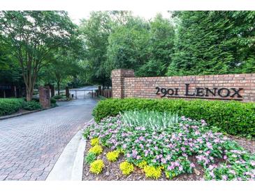 Landscaped entrance to 2901 Lenox featuring brick signage and mature trees at 2901 Lenox Ne Way # 902, Atlanta, GA 30324