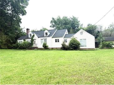 Charming single-story home with a manicured lawn and traditional architectural details at 2535 Glenwood Se Ave, Atlanta, GA 30317