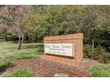 Brick community sign for Mount Vernon Towers Condominiums, set amidst mature landscaping and colorful flower beds at 300 Johnson Ferry Ne Rd # B411, Atlanta, GA 30328