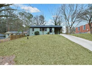 Charming single-story home features a well-maintained lawn and a convenient covered carport at 488 Park Valley Nw Dr, Atlanta, GA 30318