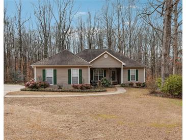 Charming one-story home with a well-manicured lawn, beautiful landscaping and inviting entrance at 7295 Hickory Bluff Dr, Cumming, GA 30040