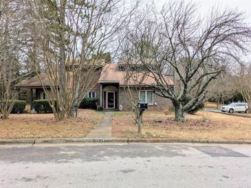 Charming brick home with a well-maintained lawn and mature trees in a quiet neighborhood at 1554 Circlestone Dr, Stone Mountain, GA 30088