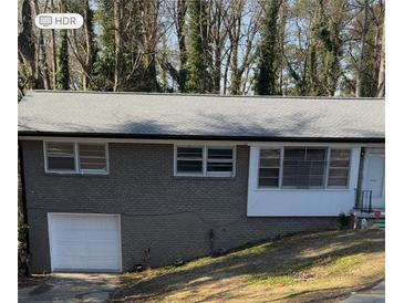 Charming single Gathering home featuring an attached garage and a well-maintained yard at 3188 Shallowford Ne Rd, Atlanta, GA 30341