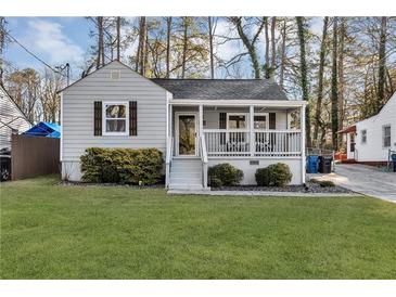 Charming home featuring a welcoming front porch and a well-maintained lawn at 2912 Palm Dr, Atlanta, GA 30344