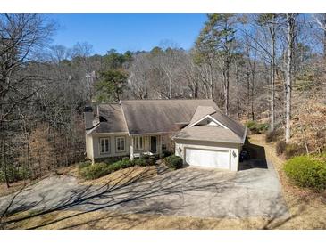 Charming single-Gathering home featuring a two-car garage, landscaped yard, and inviting front porch at 3854 W Nancy Creek Ne Pl, Brookhaven, GA 30319