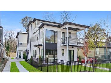 Modern two-story home boasting sleek black trim, large windows, a balcony, and a well-manicured front yard with black fence at 1137 Hardee Ne St # B, Atlanta, GA 30307