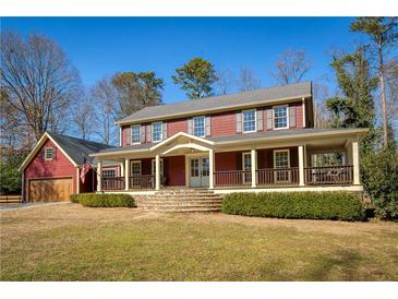 Charming two-story home featuring a spacious front porch, stone steps, and a well-manicured front yard at 260 Pinebrook Way, Roswell, GA 30076