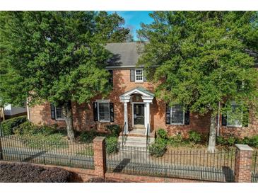Charming brick home with a manicured lawn and lush, mature trees adding to its curb appeal at 6700 Roswell Rd # 32C, Atlanta, GA 30328