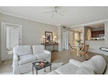 Bright living room with neutral tones, ceiling fan, comfortable seating, and view of dining area at 2310 River Green Nw Dr, Atlanta, GA 30327