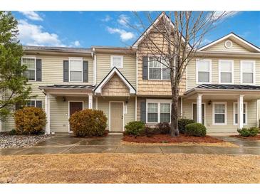 Inviting townhome exterior with covered entry, neutral siding, well-kept landscaping, and mature trees at 3541 Parc Sw Cir, Atlanta, GA 30311