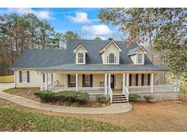 Charming two-story home featuring a large, inviting front porch and traditional architectural details at 3773 Galdway Dr, Snellville, GA 30039
