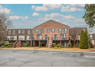 Inviting brick townhouse complex with well-maintained landscaping and a clear view of unit entrances at 3091 Colonial Way # D4, Atlanta, GA 30341