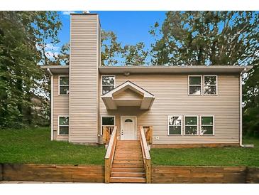 Charming two-story home with a welcoming front porch and well-maintained lawn at 6350 Akins Way, Cumming, GA 30041
