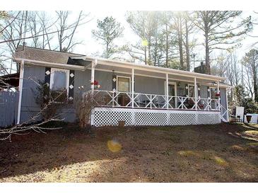 Charming ranch home with a covered porch and a well-maintained front yard at 7240 Colony Ln, Douglasville, GA 30135