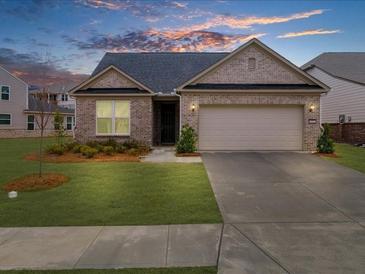 Charming single-story brick home with a well-maintained lawn and attached two-car garage at 6451 Crest Brook Way, Buford, GA 30518