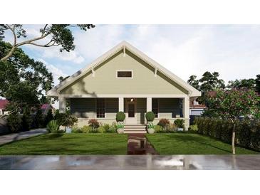 Charming home featuring a lush front lawn, covered porch, and traditional architectural details at 60 Douglas Se St, Atlanta, GA 30317