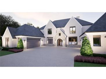 Stunning two-story home with stone accents, arched entry, lush landscaping, and attached three-car garage at 4428 Blackland Dr, Marietta, GA 30067