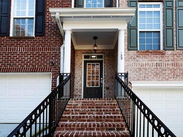 Charming brick home with a welcoming front entrance, black door with glass panes, and wrought iron railing at 132 Wetherbrooke Ln # 3, Smyrna, GA 30082