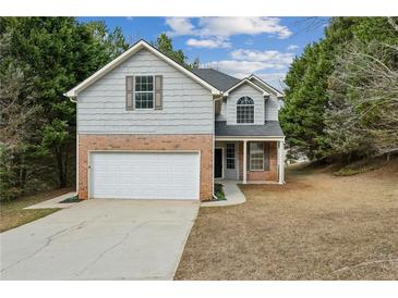 Charming two-story home with a two-car garage, brick accents, and a well-maintained front yard at 2704 River Summit Ln, Decatur, GA 30034