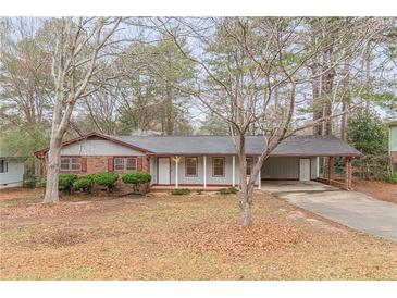 Charming single-story home featuring a covered carport and inviting front porch at 50 Carriage Trce, Stockbridge, GA 30281