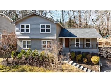Charming two-story home with a gray facade, complemented by a well-manicured front yard at 3044 Windfield Cir, Tucker, GA 30084