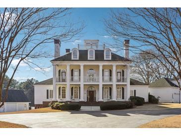 Stately colonial home with grand entrance featuring white columns and symmetrical design at 2595 Ross Rd, Snellville, GA 30039
