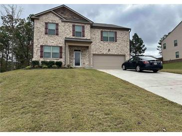 Charming two-story home featuring brick facade, and a well-manicured lawn at 738 Basswood Ave, Mcdonough, GA 30252