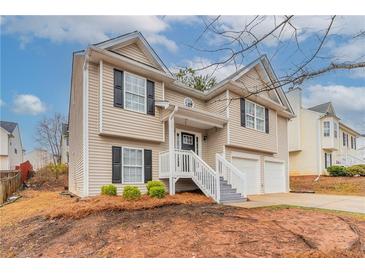 Charming two-story home with vinyl siding, black shutters and a two car garage at 6557 Snow Bird Ln, Douglasville, GA 30134