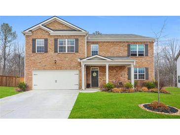 Inviting two-story brick home with a well-manicured lawn and attached two-car garage at 2713 Serena Way, South Fulton, GA 30331