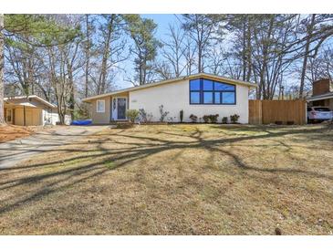 Charming single-story home featuring a white brick facade, large windows, and a well-maintained lawn at 3180 Vine Cir, Decatur, GA 30033