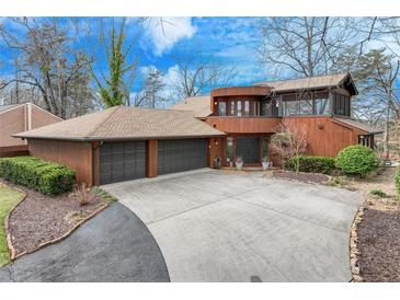 Stunning two-story wood home featuring an oversized three-car garage and circular driveway at 4110 Sinclair Shores Rd, Cumming, GA 30041