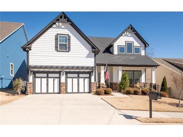 Charming two-story home featuring a two-car garage and manicured lawn at 515 Windy Ridge Ct, Canton, GA 30114