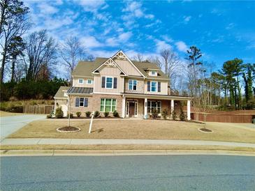 Beautiful two-story home with a manicured lawn, craftsman-style details, and a welcoming front porch at 4188 Gunnerson Ln, Kennesaw, GA 30152