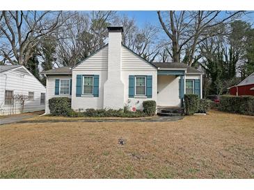 Charming white brick home features blue shutters, a cozy porch, and a classic chimney at 1322 Lorenzo Sw Dr, Atlanta, GA 30310