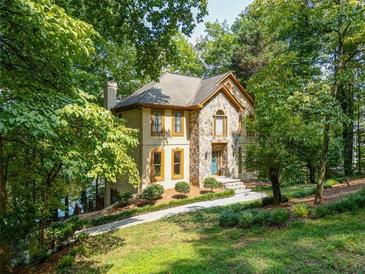 Charming two-story home featuring a stone facade and well-maintained landscaping at 18 Commerce Row, Cartersville, GA 30121