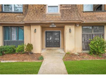 Condominium exterior featuring a well-maintained landscape, a peaked roof, and inviting entrance at 3100 Parc Lorraine, Lithonia, GA 30038