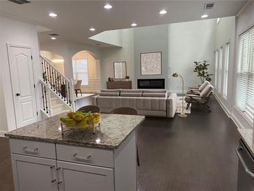 Bright, airy living room features fireplace, high ceilings, and modern decor at 868 Still Hill Ln, Lawrenceville, GA 30045