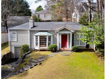 Charming one-story home featuring a red door, bay window, and beautifully landscaped front yard with stone walkway at 2836 Alpine Ne Rd, Atlanta, GA 30305