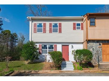 Charming two-story townhouse with light siding and red shutters, nestled in a suburban community at 2102 Lenoa Ln, Austell, GA 30106