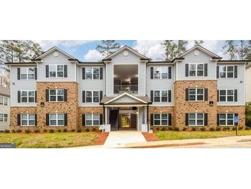 Well-maintained apartment complex with brick accents and ample parking at 5301 Fairington Club Dr, Lithonia, GA 30038