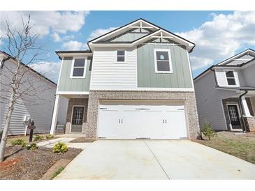 Charming two-story home with a brick-accented facade and a spacious two-car garage at 2778 Aralynn Way, College Park, GA 30337