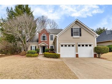 Charming two-story home with a manicured lawn and a two-car garage at 203 Bent Oak Ln, Woodstock, GA 30189