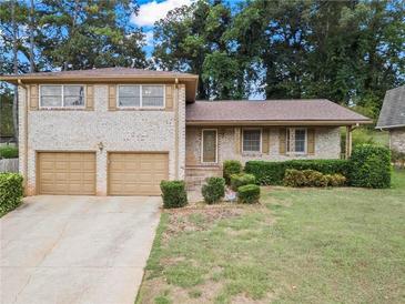 Charming two-story brick home with well-manicured landscaping and a two car garage at 3710 Oregon Trl, Decatur, GA 30032