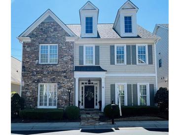 Charming two-story home featuring stone accents, gray shutters, and manicured landscaping at 1580 Reids Ferry Way, Marietta, GA 30062