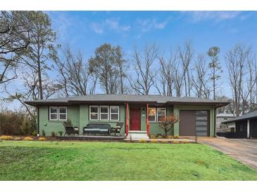 Charming home featuring a vibrant green exterior, red door, and cozy front porch seating area at 1322 Elmhurst Circle Se Cir, Atlanta, GA 30316