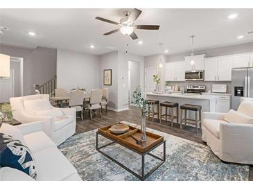 Open concept living area flows into dining and kitchen, offering modern living space at 5603 Hislop Ln # 79, Mableton, GA 30126