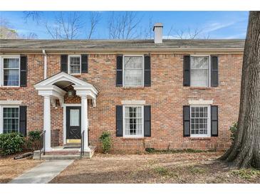 Charming two-story brick condo featuring black shutters and a welcoming front entrance at 6700 Roswell Rd # 11B, Atlanta, GA 30328