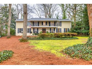 Charming two-story home with a welcoming front yard and manicured greenery at 192 Maple Wood Dr, Lawrenceville, GA 30046