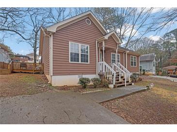 Charming home featuring a wood facade, a welcoming front porch, and a well-maintained front yard at 2024 Collier W Cir, Decatur, GA 30032