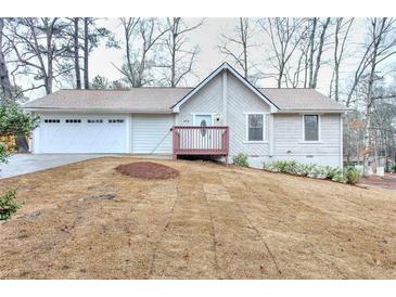 Charming single-story home featuring a two-car garage and a cozy front porch at 2370 Old Mill Sw Dr, Conyers, GA 30094